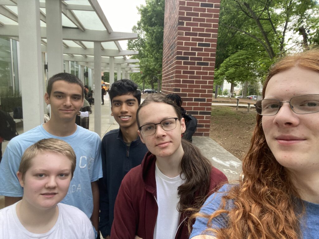 5 students looking into the camera