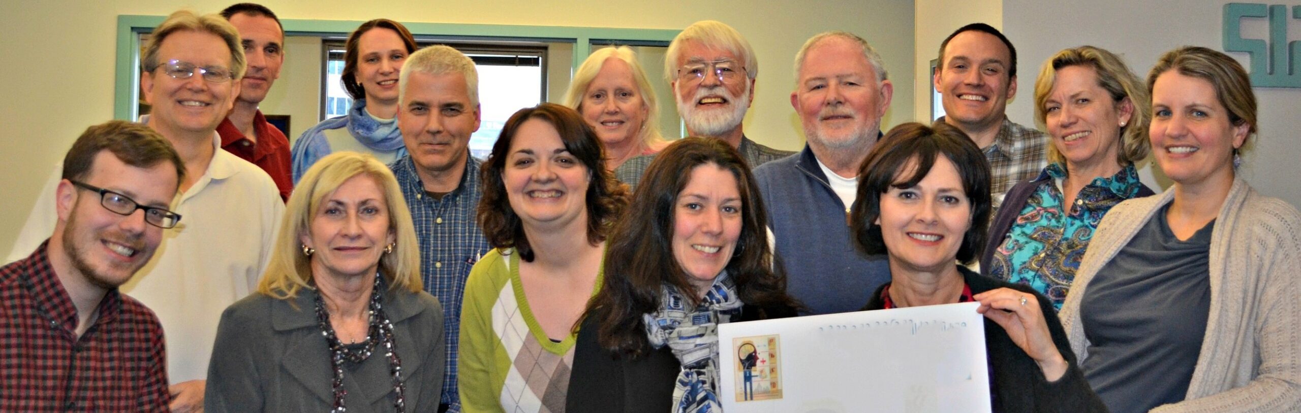 judges in a row holding welcome sign