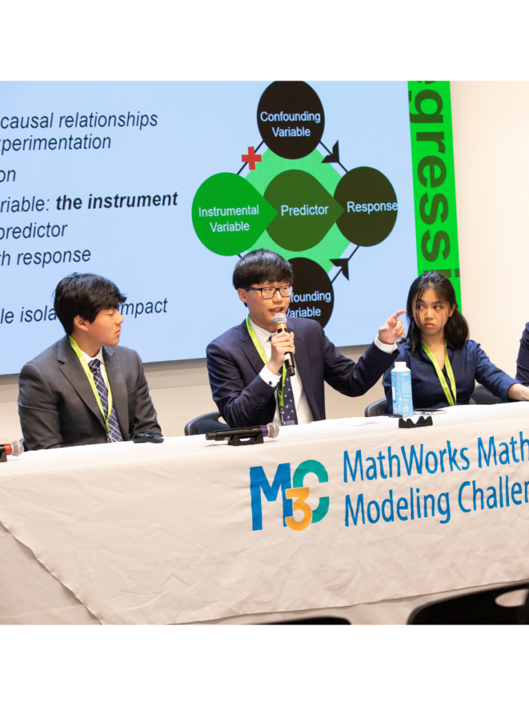 Three students presenting at the M3 Challenge final event.
